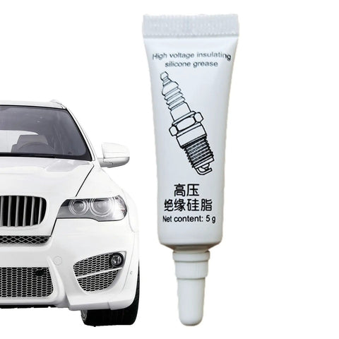 Dielectric Lubricant For Electronics And Automotive Weatherproof Silicone Grease High Temperature Insulating Compound Anti Corrosion Sealant For Spark Plugs And Ignition Systems Keeps Electrical Contacts Smooth And Protected No Fuss, 5g tube next to a car