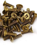 Heavy Duty Brass Fasteners Featuring Flat Countersunk Phillips Heads Top Shelf Self Tapping Machine Screws in a pile.