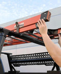 Person loading a ladder onto a truck roof rack using Built Tough 23.5 Inch Powder Coated Aluminum Ladder Roller.