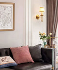 Living room with modern brass wall lamp with white cotton drum shade matte warm antique finish easy install sconce.