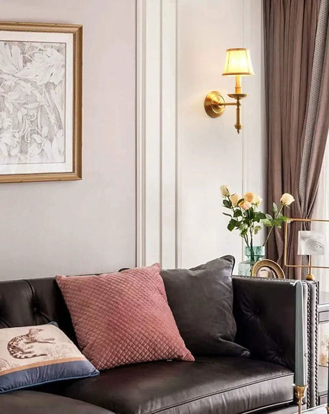 Living room with modern brass wall lamp with white cotton drum shade matte warm antique finish easy install sconce.