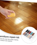Hand using Floor Repair Kit With Quick Heating Wax Block Sponge For Laminate And Hardwood Floors And Tile Scratches.