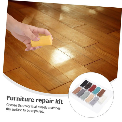 Hand using Floor Repair Kit With Quick Heating Wax Block Sponge For Laminate And Hardwood Floors And Tile Scratches.