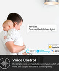 Man holding baby using HomeKit Smart Light Switch That Plays Nice With Siri, Alexa, And Google Home, voice control feature displayed