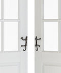 Gecko Shaped Door Pull Handles Set Of 2 In Rustic Dark Coffee Cast Iron on white interior doors, side view showing desert theme design.