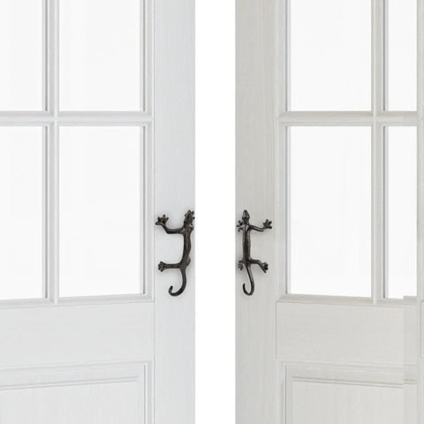Gecko Shaped Door Pull Handles Set Of 2 In Rustic Dark Coffee Cast Iron on white interior doors, side view showing desert theme design.