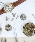 Clock Winding Key For Mechanical Clocks, Pro Repair Tool, metal parts and gears for vintage alarm clocks on workbench