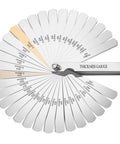 Stainless steel thickness gauge with 32 blades fanned out, showing metric and imperial markings.