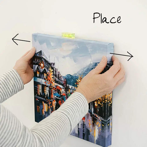 Placing a canvas using Place And Push Canvas Hangers For Drywall, 20 Pound Capacity, with flush mount finish and mini level