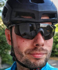 Kickass Safety Glasses With Swappable Polycarbonate Lenses and Wraparound Shield delivering heavy duty eye protection worn by cyclist.