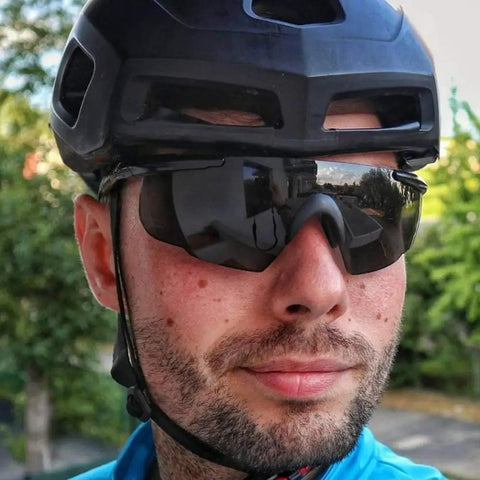 Kickass Safety Glasses With Swappable Polycarbonate Lenses and Wraparound Shield delivering heavy duty eye protection worn by cyclist.