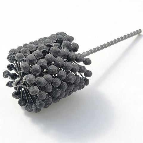3-inch cylinder hone tool with 240-grit silicon carbide ball abrasive; close-up view