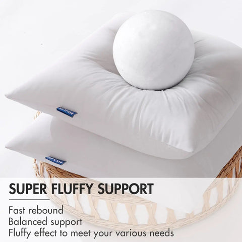 Two white, fluffy pillows on a wicker basket demonstrating softness with a white ball; labeled 'Super Fluffy Support'