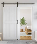 36 By 84 Inch White Sliding MDF Barn Door With Six Point Six Foot Black Sliding Door Hardware Kit And Handle Pre Drilled Ready To Assemble Waterproof PVC Coating H Frame Durable Primed MDF And PVC Construction For Water Resistance And Stable Performance installed in a living space.