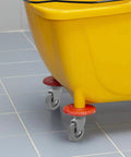 4 Piece Heavy Duty Rubber Swivel Caster Wheels With Threaded Stem And Spring Loaded Setup For Slick Rolling On Mop Buckets Trash Dolly Furniture Carts Grey attached to yellow mop bucket.