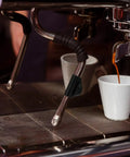 Steam Wand Rubber Insulation Sleeve For Espresso Machine Heat Resistant Cover installed on a steam wand next to cup