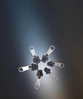 Six Black Universal Zipper Repair Kit Sliders Instant Fix for Jackets Bags and Pants displayed in a circle on a dark background.