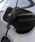 Heavy Duty EV Charging Port Cover Keeps Your Electric Ride Safe With All Season Weatherproof Shields Strong Mag Grip Blocks Rain Snow Ice And UV Rays For Rock Solid Charging Connection In Matte Black on an electric vehicle.