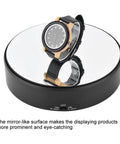 Mirror Surface Motorized Turntable Display Stand With 360 Degree Rotary Motion And Adjustable Speed showcasing a watch.