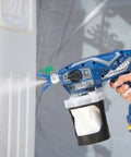 Cordless Handheld Paint Sprayer Generates Slick Airless Finishes Without Thinning, blue sprayer painting door with power source.