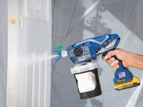Cordless Handheld Paint Sprayer Generates Slick Airless Finishes Without Thinning, blue sprayer painting door with power source.