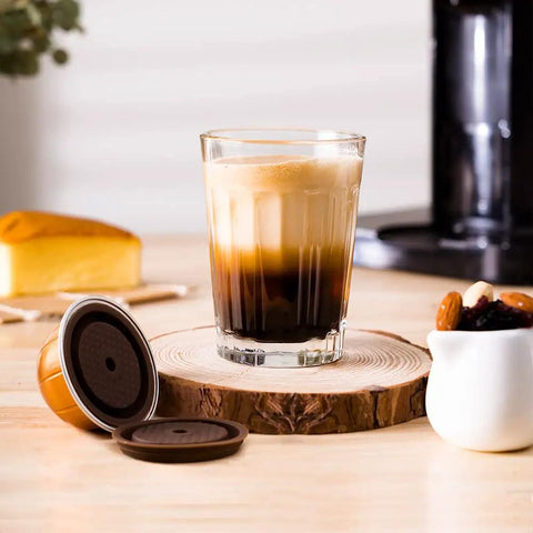 Coffee made with Upgrade Your Coffee Game With This Reusable Capsule Set For VertuoLine Machines next to refillable pod on table