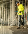 Worker applying No Sweat Setup Self Leveling Concrete Underlayment 50 Lb Bag for smooth interior flooring.