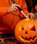 Afantti 31 Piece Electric Hot Knife Foam Cutter Kit with 23 Plastic Cutting Blades used to carve a pumpkin.