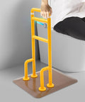 Chair And Couch Stand Assist Bar With Auto Light For Easy Getting In And Out, Yellow, shown in use beside a chair