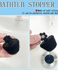 2 Pack Universal Silicone Bathtub Drain Stopper Plug For Tub And Sink Drains Black With No Fuss Seal in hand near sink