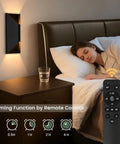 Nsleaiy Wireless Wall Sconces Set of Two, Rechargeable Wall Lights illuminating a bedside while a person sleeps.