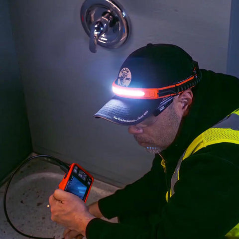 Worker using Rechargeable Wide Beam Headlamp With Strap And 575 Lumens Five Lighting Modes All Day Runtime Direct Focus And Hard Hat Compatibility