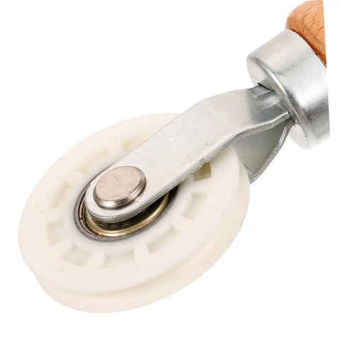 Close-up of Screen Roller Tool With Bearing For Window Screen Repair, lightweight wooden handle, smooth wheel mechanism.