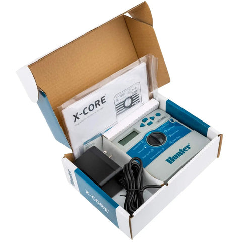 X Core XC400i Indoor Sprinkler Timer Four Zone Irrigation Controller in box with accessories.