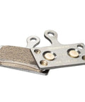 Close-up of G04Ti Metallic Disc Brake Pads with Titanium Backing Plate, showing the metallic surface and attachment holes.