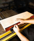 Next Level Miter Gauge with 22-to-36-Inch Extension Fence and 27 Positive Angle Stops enabling precise measurement on a wood table.
