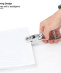 Hand using all metal handheld hole slot puncher for ID cards and paper crafts with 5.4 inch oval punch and spring mechanism on a notebook