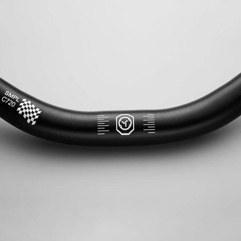 Close-up of Smpl Mountain Bike Handlebar 31.8mm Diameter 50mm Rise 720mm Width Aluminum Alloy Black with markings on matte finish.