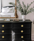 Elevate Your Vibe With These Charming Bee Cabinet Knobs Set Of 8 Golden Drawer Pulls For Dressers And Wardrobes Heavy Duty Zinc Alloy Bedroom Furniture Handles Screws Included on a black dresser with a mirror and greenery.