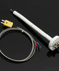 K thermocouple kiln probe with white ceramic insulator tube, braided stainless lead, and yellow terminal block