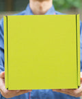 Person holding 10 Pack Green Corrugated Shipping Boxes For Mailing And Transport, Sturdy No Tape Or Glue Assembly