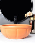 Round Sink Bowls For Bathroom Vessel Sink, 15.7 Inch Ceramic Vessel Sink with orange finish and faucet on countertop.