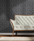 Gray Dandelion Silver Metallic Wallpaper Featuring Fibrous Texture And Eco Friendly PVC Free Finish Super Slick Paste The Wall Application For Totally Legit Chic Vibes behind a stylish white tufted loveseat.