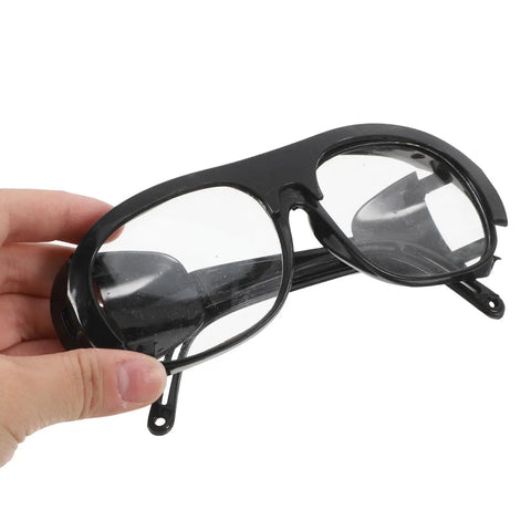Professional Grade Welding Safety Glasses With Flip Up Lens For Argon Arc And Metalworking 6 Pack being held by hand.