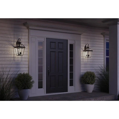 Burlington Three Light Large Wall Lantern With Clear Beveled Glass In Polished Nickel And Antique Bronze Finish illuminating entryway