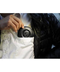 Person placing Donut Power Strip With Five Sockets And Two USB Ports, Space Saving Accessory, 1500 Watts At 240V in pocket