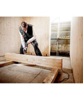 Person using Beast 1300W Hammer Drill With Impulse Mode For Damaged Screw Removal in wooden frame construction.