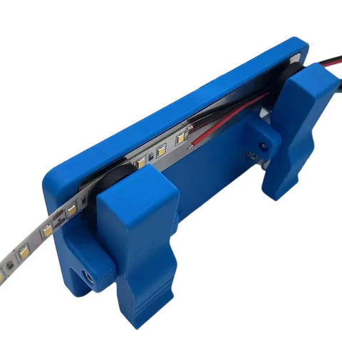 Super Grippy LED Strip Soldering Jig Helper Dual Clamp PCB Hold Down Tool securely holding LED tape strips in blue.