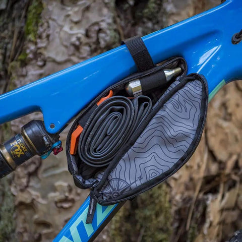 Outpost Corner Bike Bag with Built In Pockets For Gear No Seatpost Rattle Slim Frame Organizer open showing tools and inner lining