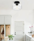 Industrial Dope Semi Flush Mount Ceiling Light in matte black with clear glass shade in a bright modern hallway setting.